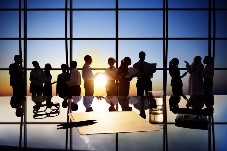 Silhouettes of Business People Working in Board Room Silhouettes of Business People Working in Board Room
